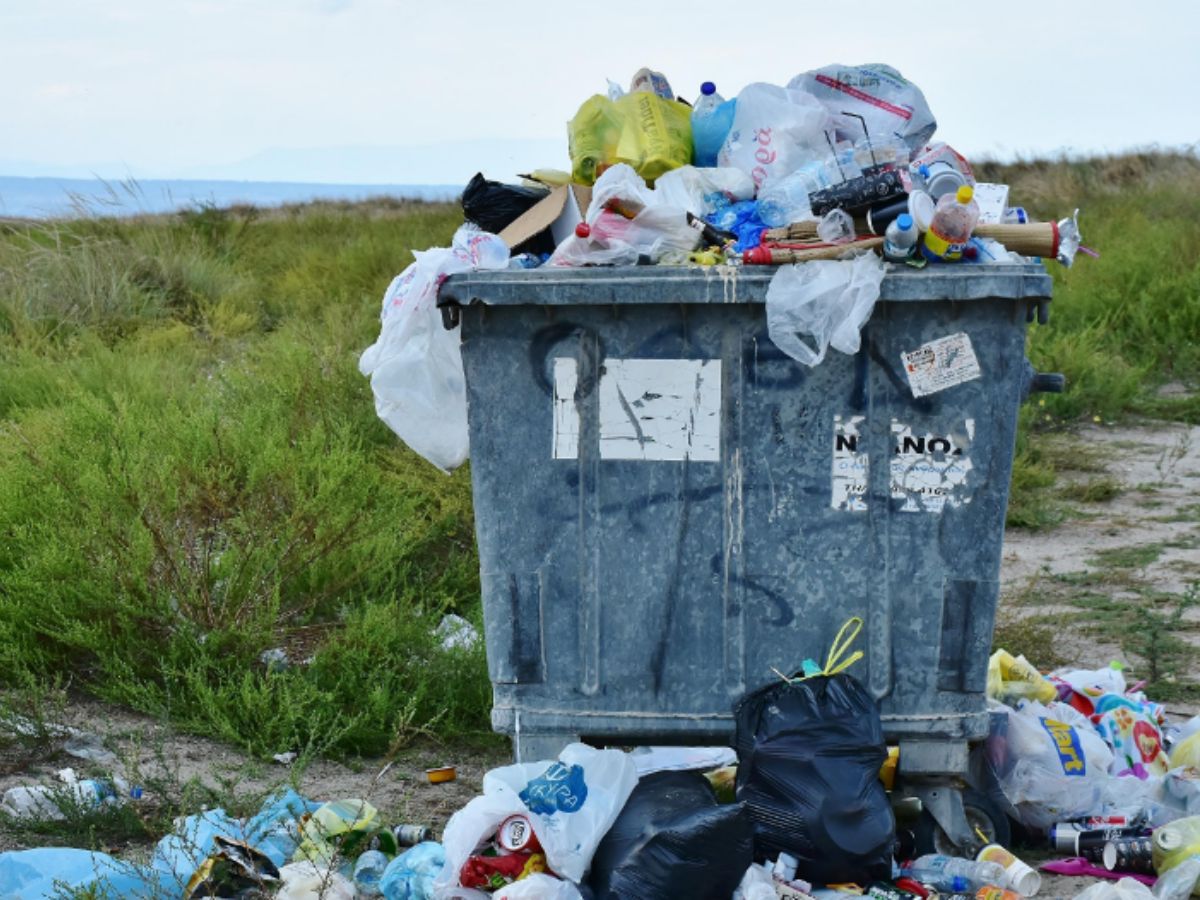 Full dumpster in a field